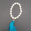 Bracelet de perles rondes à la mode européenne et américaine pompon cordon élastique pendentif porte-clés