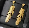 Vintage head of European and American wind gold feather earrings luxury custom brass plated S925 silver needle earrings3779354