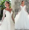 Eleganckie koronkowe sukienki ślubne A iluzja dekolt z długim rękawem Vestios de novia tiul aplikacja
