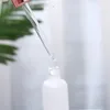 Botella de aceite esencial de vidrio transparente Botella de perfume de perfume de reactivo líquido Botella de goteta con gorra de oro rosa 5-100ml