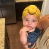 Modische niedliche Säuglingsbaby-Kind-Kleinkind-Kinder Unisex-Ball-Knoten-indischer Turban bunter Frühlings-niedlicher Baby-Donut-Hut einfarbige Baumwolle WL1198