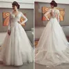 Elegant ontwerp Nieuwe kanten jurk knop Appliques Tule gelaagde rokken terug naar achteren lange mouw v-neck glamoureuze trouwjurken Vestidos de novia