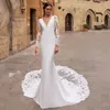2023 Långärmad Bröllopsklänning Sjöjungfru V-hals Spets Applikationer Brudklänningar Rygglösa brudklänningar Turkiet Vestido de noiva