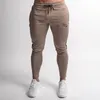 Мужские Joggers Повседневная Брюки Фитнес Мужской Спортивная одежда Косцейстраз Нижние Днищие Двухфустные Успонатыватели Брюки Черные залы Джорганизаторы Трек Брюки