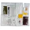 7 * 10cm, 100pcs / lot Transparence avant Blanc BOPP PearlﾠFilm Zipper Lock Bag, Poche d'emballage de batterie réouvrable, Pack Sacs en plastique pour écouteurs