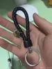 Fashion unisex de cuero trenzado cuerda hecha a mano llavero de llavero de cuero soporte para la cadena de llaves para el automóvil llagues para hombres llaves 285t