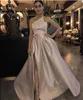 Elegant Prom Dress with pockets 2019 A Line Satin asymmetric Strapless High side Slit Dubai Saudi Arabic Long Evening Gown evening gowns