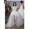 Ines di Santo Lace Jumpsuit Bröllopsklänningar 2019 Nya två i ett avtagbart tåg Sheer Cap Sleeve Illusion Bodice Overskirt Bridal Gowns