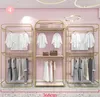 衣料品店ディスプレイシェルフ黄金の床の種類二重照明高級創造的な鉄ぶら下げ衣服ラック婦人服屋の棚