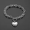 Hela eller detaljhandels charmiga 316L rostfritt stål silverfärgguld Rolo Oval Link Chain med Solid Heart Mens Womens Armband245y