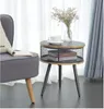 tavolo rotondo con deposito grigio accanto al divano mobili da soggio