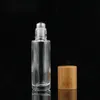 5 ml 10ml Essential Oljevalsflaskor Klar glasrulle på parfymflaska med naturlig bambu keps rostfritt stål rullboll