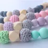 Massaggiagengive in legno per bambini Perline in silicone Anello per dentizione Bracciale Sonagli fatti a mano Porta ciuccio Giocattoli 2 pezzi set1067439