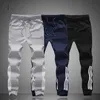 2020 wiosenne męskie spodnie modne obcisłe spodnie dresowe męskie biegaczy w paski dopasowane spodnie odzież Plus rozmiar 4XL spodnie haremki