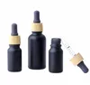 Frascos cuentagotas de vidrio de suero de aceite esencial negro mate de 10ml 30ml más vendidos para envases cosméticos con tubo de tapa de bambú de plástico