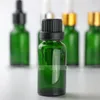 Flacon compte-gouttes en verre vert 20ml Emballage cosmétique d'huile essentielle avec couvercles en or noir argenté