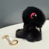 Söt äkta äkta päls dinosaury leksak pompom boll väska charm keychain pendant barn gåva