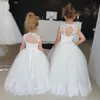 最新のフラワーガールドレスラインシアークルーネックノースリーブレースアップリケ床の長さの女の子の結婚式パーティードレスリトル花嫁