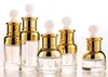 Högkvalitativa eteriska oljedroppflaskor 20ml 30ml 50 ml glas essensflaska med guldkåpa för kosmetisk packning