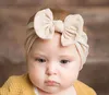 0-7歳の赤ちゃんの弓ナイロンヘッドバンド幼児の女の子の柔らかい弾性ナイロンヘッドバンドキャンディーカラーノット弓ターバンヘッドのヘアバンド