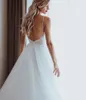 Abiti da sposa da spiaggia 2020 Appliques in pizzo senza schienale Perle Cinghie senza spalline A-Line Boho Abiti da sposa Robe De Mariee economici