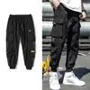 브랜드 디자이너 Spring Hip Hop Joggers 남자 블랙 하렘 멀티 포켓 리본 남자 스웨트 턴스 스트리트웨어 캐주얼 남성화물 바지