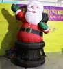 Outdoor Inflatable Christmas Santa Claus Carrying A Gift Bag Climbing Out From The Chimney For Christmas Decoration