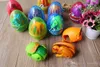 12PCS / Lot Dinosaur World Dinosaur Egg Deformed Ultraman Divertenti uova di Pasqua Aiuta i bambini a esplorare giocattoli sconosciuti