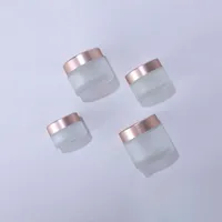 Nieuwste frosted glazen pottenroomflessen ronde vorm cosmetische containers met roze gouden pet voor gezicht crème make-up verpakking