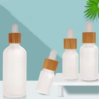 Botella de gotero de vidrio transparente esmerilado con tapa de bambú Embalaje de cosméticos Embalajes Líquidos Recipientes cosméticos
