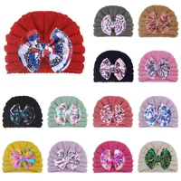 素敵な快適なベビーウールの帽子甘い印刷された弓冬の暖かい肌に優しい皮の帽子の西部スタイルの赤ちゃんの贈り物