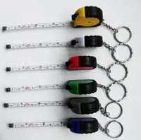 Mini cinta de medida caliente con llavero de plástico portátil 1 m Regla retráctil centímetro / pulgadas cinta métrica
