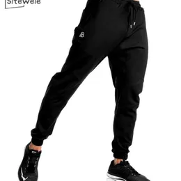 SITEWEIE Nuovi pantaloni sportivi da uomo autunno Pantaloni slim elasticizzati Fitness Palestra Pantaloni sportivi in cotone Pantaloni sportivi in cotone Lunghezza intera L250 201113