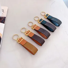 Oficjalny Oryginalny Luksusowy Projektant Skórzany Keychain Paski Moda Kobieta Męskie Śliczne Długie Wysokiej Jakości Złoty Klucz Łańcuch LL Wzór Metal Wisiorek Dekoracja