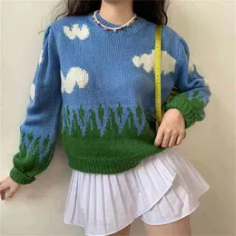 女性の子供のような無邪気な白い雲と緑の草のニットのセーターとパフスリーブ210512