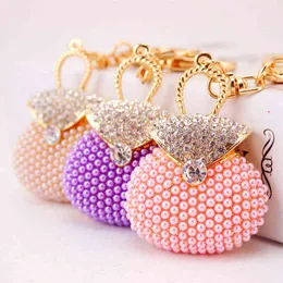 クリエイティブかわいいピンクの真珠のハンドバッグモデリングキーチェーンの女性バッグアクセサリーメタルペンダントロマンチックなギフトAA220318