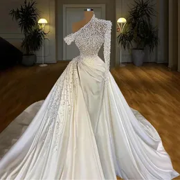 Moderna Asymmetriska Beading Pearls Dubai Ball Gown Wedding Dress One Shoulder Långärmad Satin Saudiarabiska Bröllopklänning med avtagbart tåg