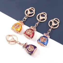 Pauli Manfi 2021 Fashion Metal Dripping Blessing Bag Keychain Female Car Key Ring Backpack Pendant Campus Accessories AA220318