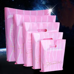 Enrolamento de presentes 50pcs Rosa Sacos de plástico rosa Pacote de roupas de Natal com alças Baggift de compras