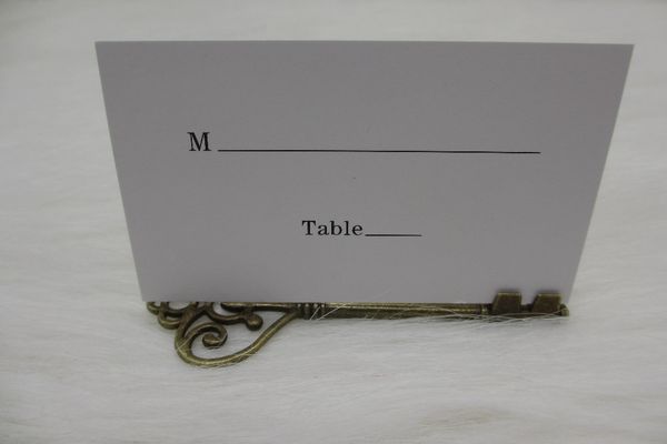Vente en gros - 100pcs / lot Faveurs de mariage Antique Bronze Squelette Porte-carte de place avec carte de lieu assortie Accessoire de décoration de mariage