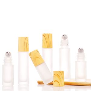 wholesale 5 ml 10 ml Botellas de rodillos de vidrio transparente esmerilado Envases de viales con bola de rodillo de metal y tapa de plástico de grano de madera para perfume de aceite esencial