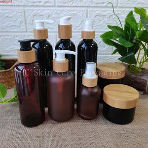 Venta al por mayor de botellas de plástico ámbar/negro esmerilado/blanco/transparente y tarros de crema botella con tapa de bambú envases cosméticos tarro a granel