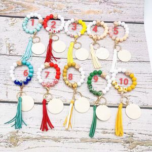 Vente en gros nouveau bracelet en perles de silicone en forme de coeur porte-clés disque vierge pendentif pompon de velours coréen options multicolores pour femmes