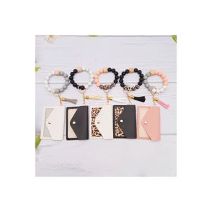 En gros de nouveaux bracelets de perles en silicone, des porte-clés, des glands en velours coréens, des sacs de ramassage PU, des pendentifs, des bracelets, des porte-clés pour le commerce extérieur