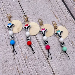 Vente en gros de porte-clés en perles de gel de silice pour le commerce extérieur, couleur vache, pendentif en bois vierge, porte-clés