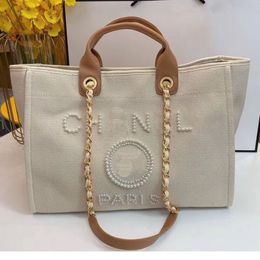 Bolsos de lujo para mujer Bolso de playa de diseñador Moda de calidad superior Monedero de hombro Tote grande con cadena Bolso de compras de lona ch230322