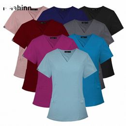 Mujeres Cirugía médica Tops con cuello en V Scrub Uniforme quirúrgico Scrubs Top Camiseta limitada Uniforme de enfermera para mascotas Spa Bank Hotel Blusa v1cL #