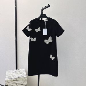 Damesjurken Europees modemerk Zwarte decoratieve mini-jurk met ronde hals, korte mouwen en vlinderkralen