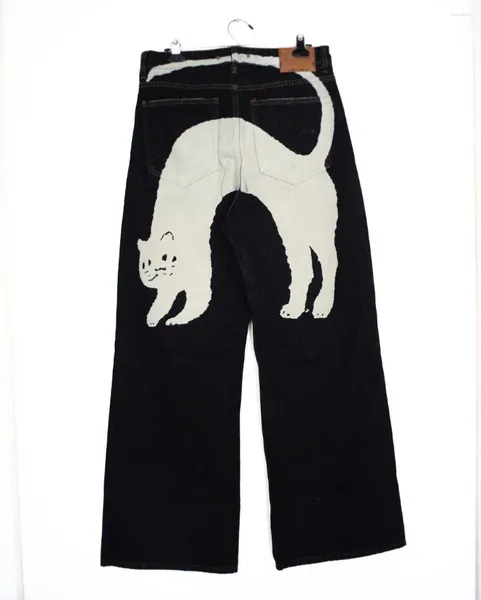 Pantalones vaqueros de mujer únicos negros con encantador diseño de estampado de gato blanco moda Harajuku Y2K personalidad casual pantalones de pierna ancha recta