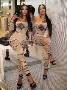 Jumpsuits voor dames rompers rare kuts sexy zie door dames 2 -delige set mode hartprint slash nek bodysuit+leggings bijpassende middernacht clubkledingpak y240521